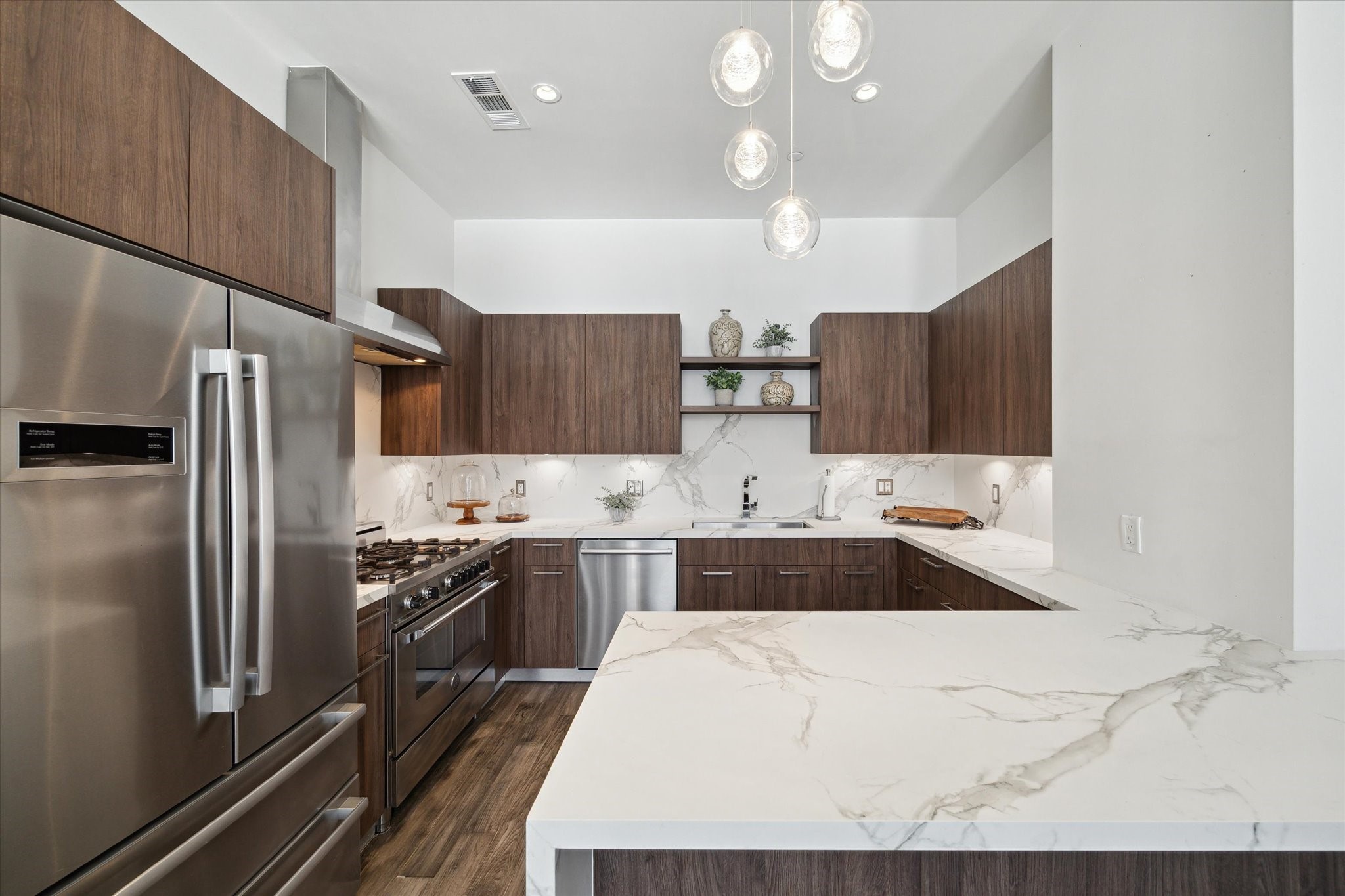 1211 Caroline Street, Unit 1007 Houston, TX 77002 - Photo 8 of 46 a large kitchen with cabinets and stainless steel appliances