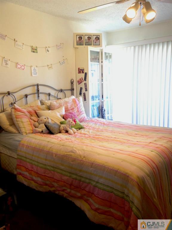 7 Spencer Street Somerset, NJ 08873 - Photo 11 of 21 a bedroom with a bed and a chandelier