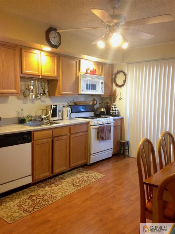 7 Spencer Street Somerset, NJ 08873 - Photo 17 of 21 a kitchen with stainless steel appliances granite countertop a sink a stove cabinets counter space and a window