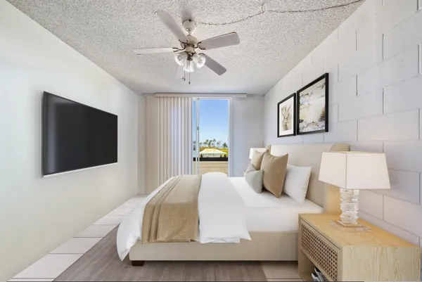 a bedroom with a bed and a flat screen tv