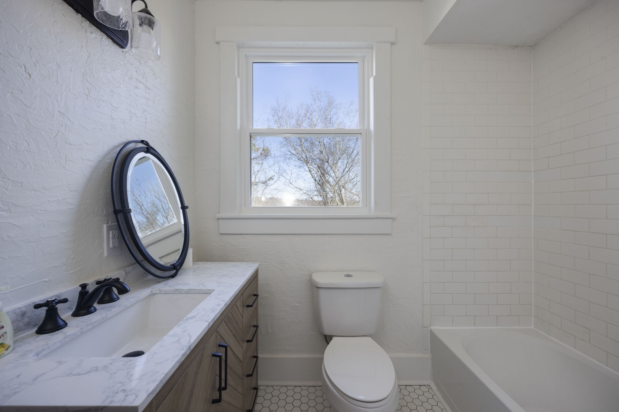607 3rd Avenue West Springfield, TN 37172 - Photo 45 of 65 a bathroom with a toilet sink a mirror and a window