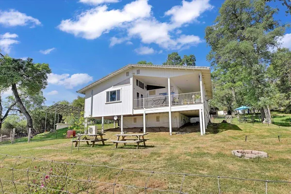a view of a house with backyard porch and sitting area