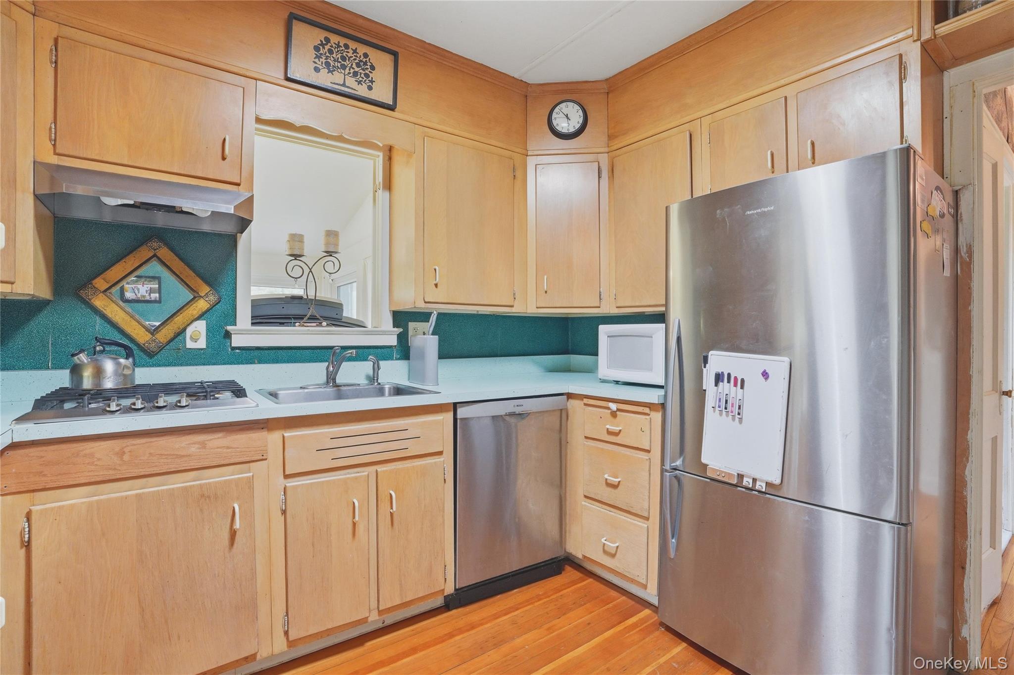167 Highland Road Cold Spring, NY 10516 - Photo 11 of 22 The kitchen features wood cabinetry, a stainless steel refrigerator, a stainless steel dishwasher, and a gas range