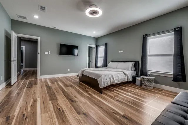 a bedroom with a bed and a large window