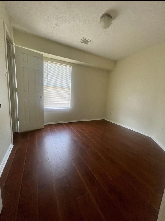 13064 Peppergate Lane Houston, TX 77044 - Photo 11 of 18 an empty room with wooden floor and windows