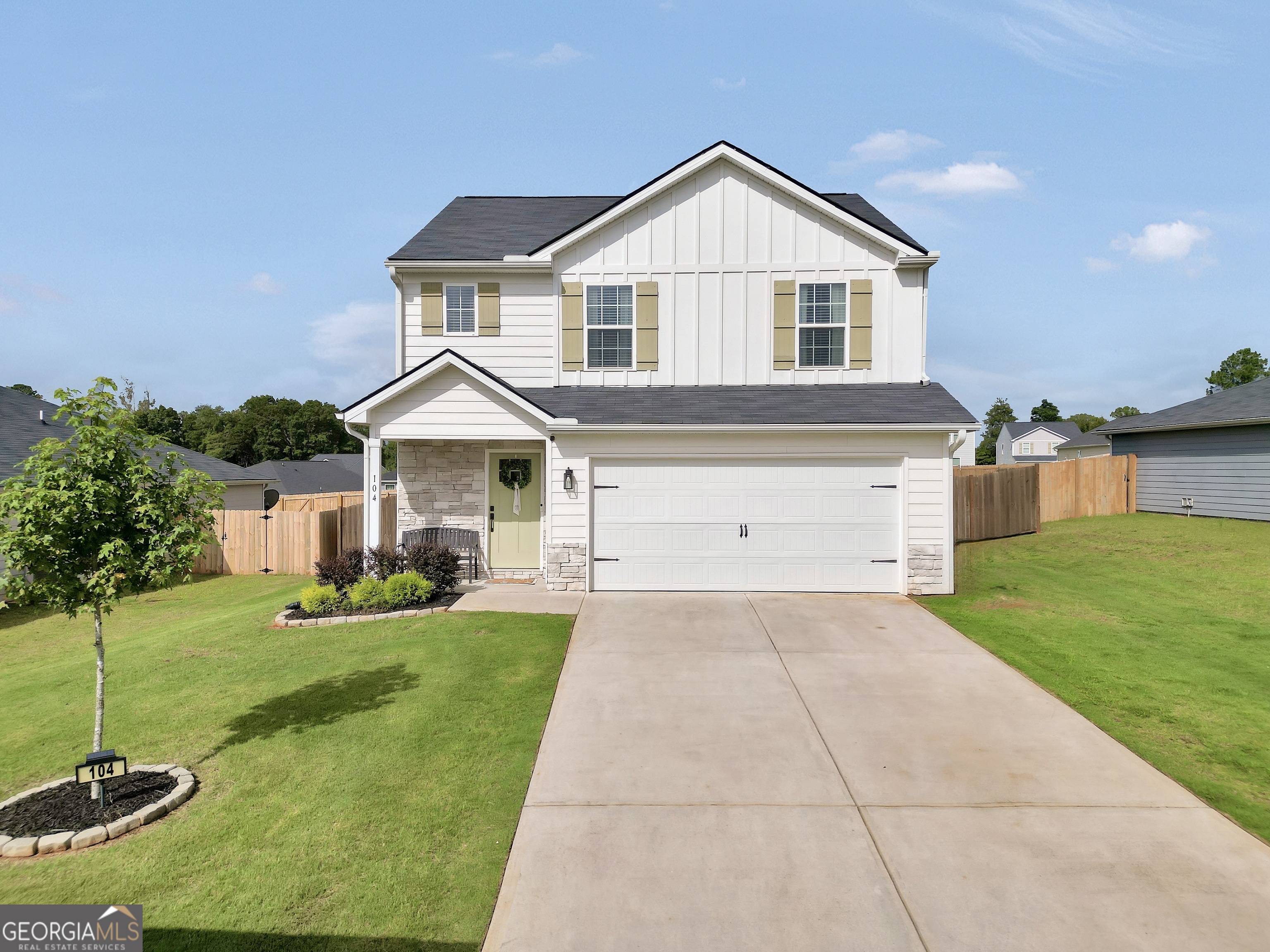 104 Maple Drive Milner, GA 30257 - Photo 1 of 1 a front view of a house with a yard table and chairs