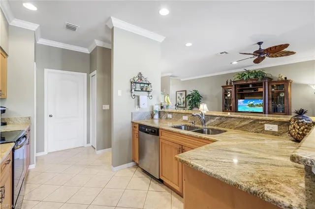 a kitchen with stainless steel appliances granite countertop a sink and a refrigerator