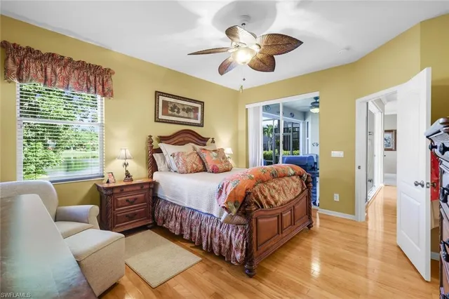 a bedroom with a bed chandelier and a window