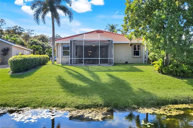 a view of a house with a yard and sitting area