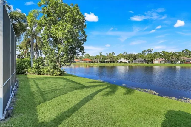 a view of a lake with houses in the back