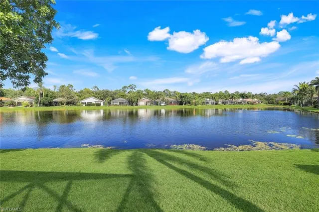 a view of a lake with houses in the back