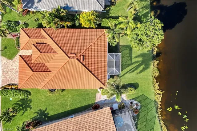 an aerial view of a house with a yard