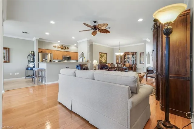 a living room with furniture a dining table and a chandelier