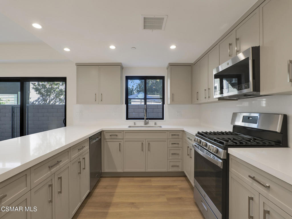 3190 Los Robles Road, Unit B Thousand Oaks, CA 91362 - Photo 6 of 21 a kitchen with stainless steel appliances granite countertop a stove a sink and a microwave