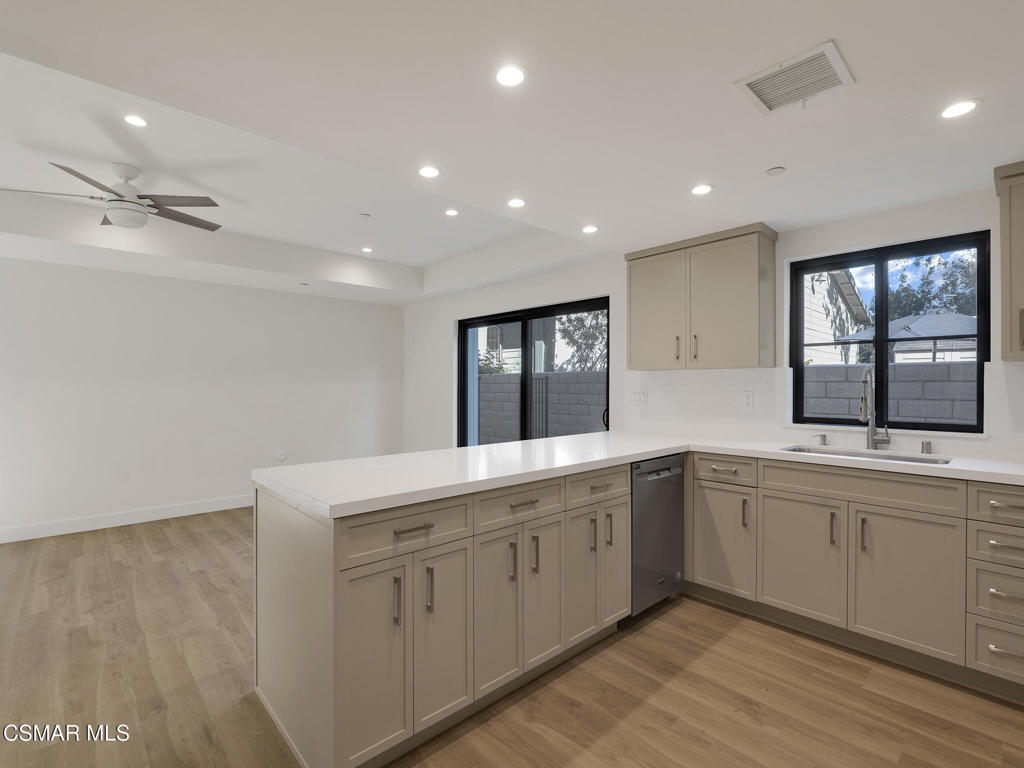 3190 Los Robles Road, Unit B Thousand Oaks, CA 91362 - Photo 7 of 21 a large white kitchen with a sink a window and stainless steel appliances