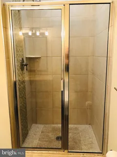 a bathroom with a glass shower door