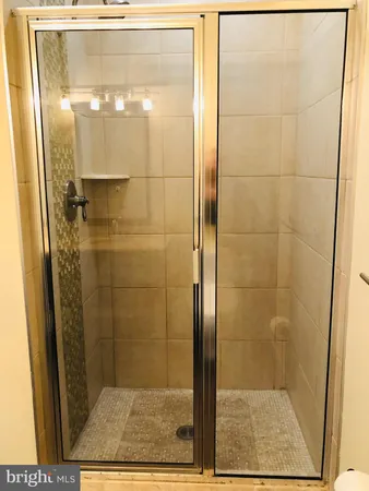 a bathroom with a glass shower door