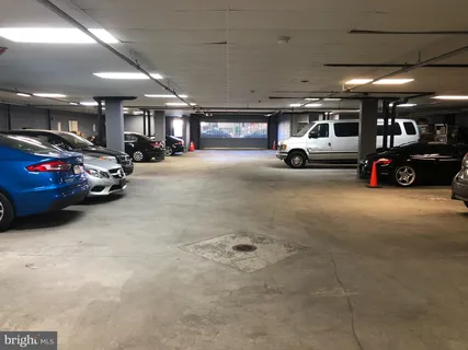a view of parking garage with cars parked
