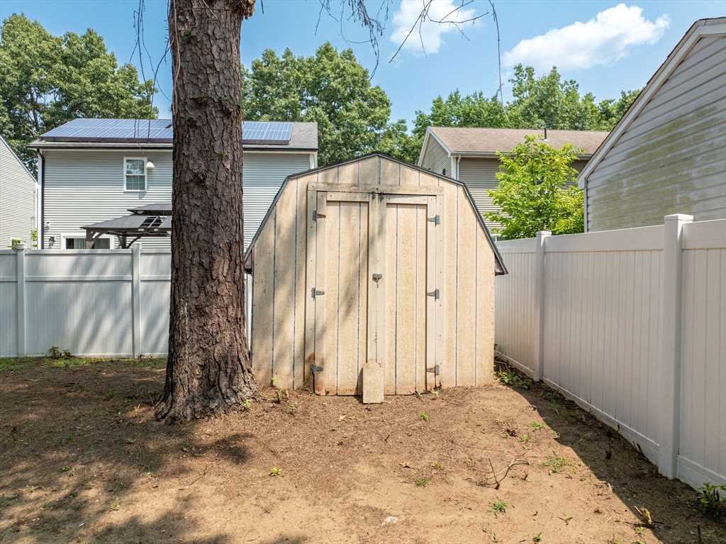 17 Delmore Street Springfield, MA 01109 - Photo 39 of 42 a backyard of a house with large trees and barn in the back