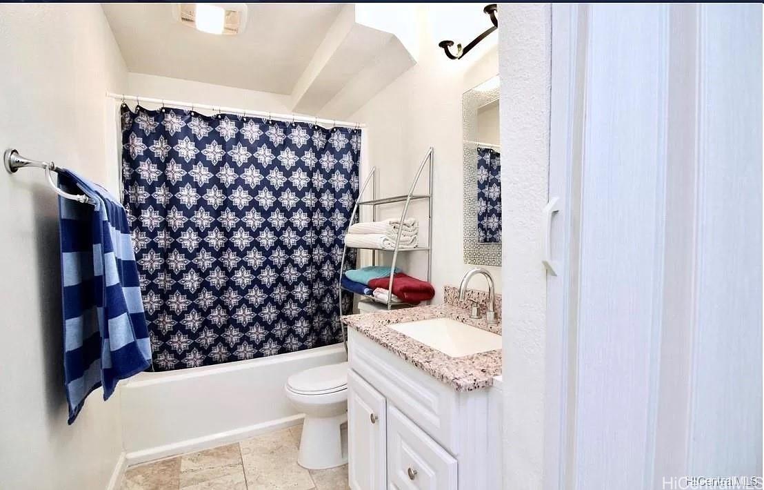 85-059 Waianae Valley Road Waianae, HI 96792 - Photo 13 of 20 a bathroom with a granite countertop toilet a sink and a mirror