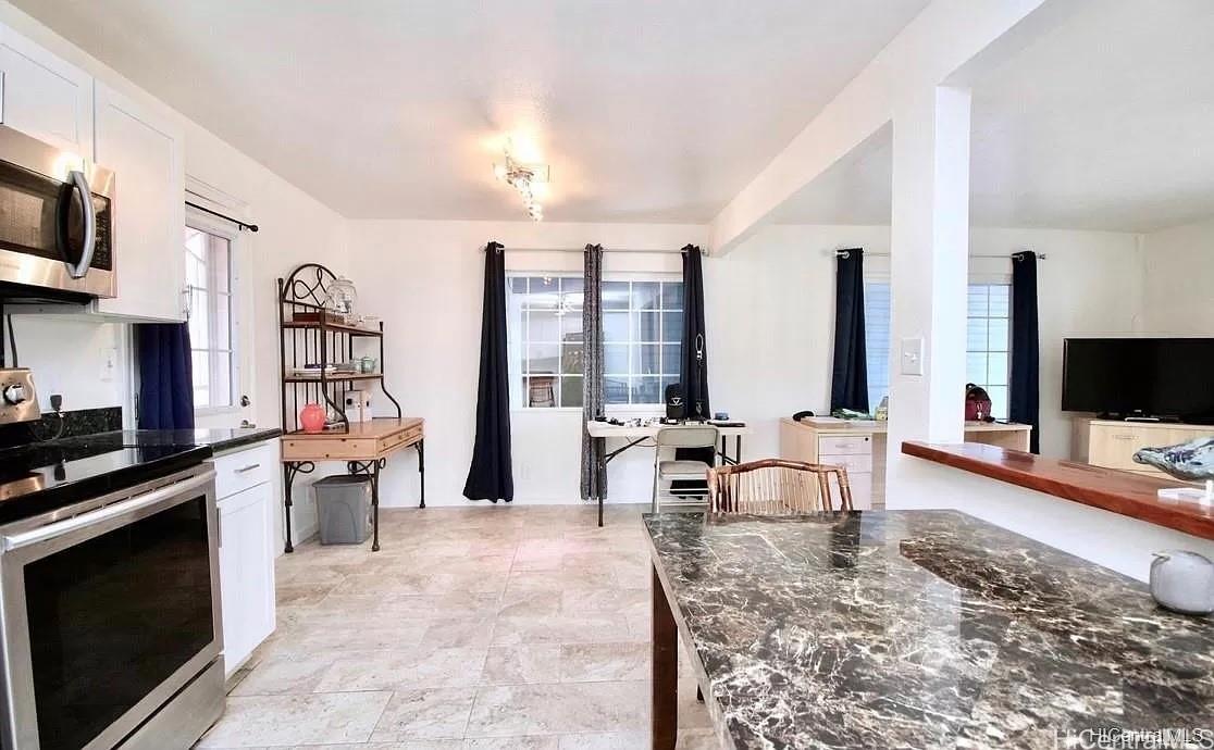 85-059 Waianae Valley Road Waianae, HI 96792 - Photo 8 of 20 a living room with furniture and a flat screen tv