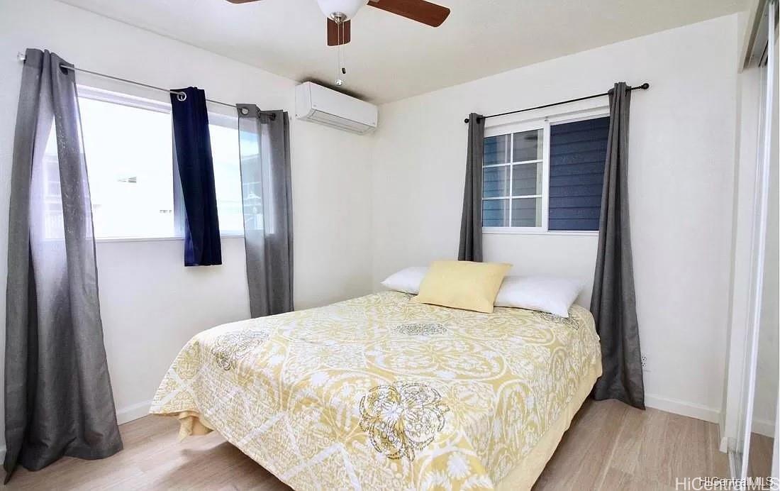 85-059 Waianae Valley Road Waianae, HI 96792 - Photo 10 of 20 a bedroom with a bed and a large mirror next to a window