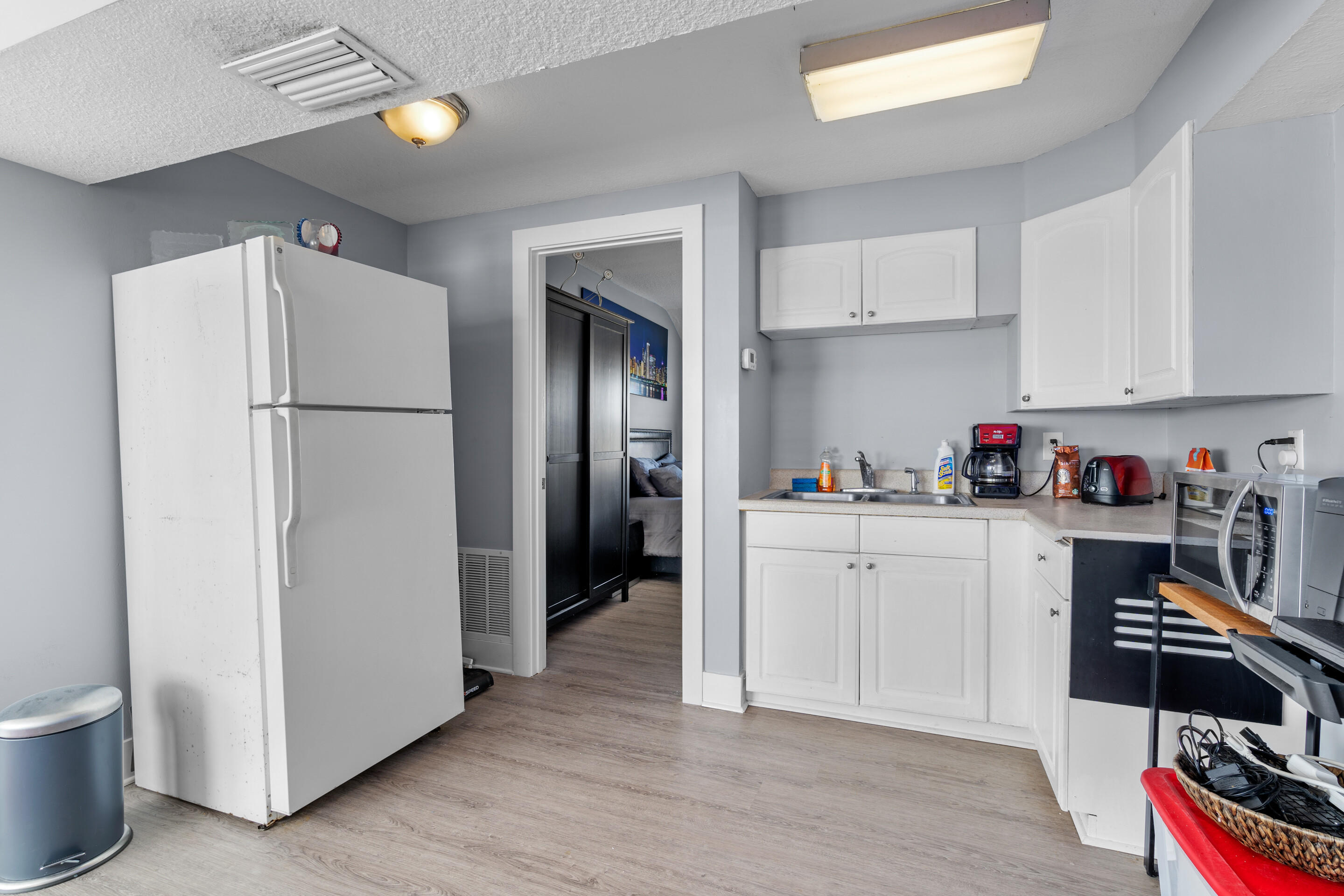 50 Cubbedge Road St. Augustine, FL 32080 - Photo 14 of 26 a kitchen with a refrigerator and white cabinets