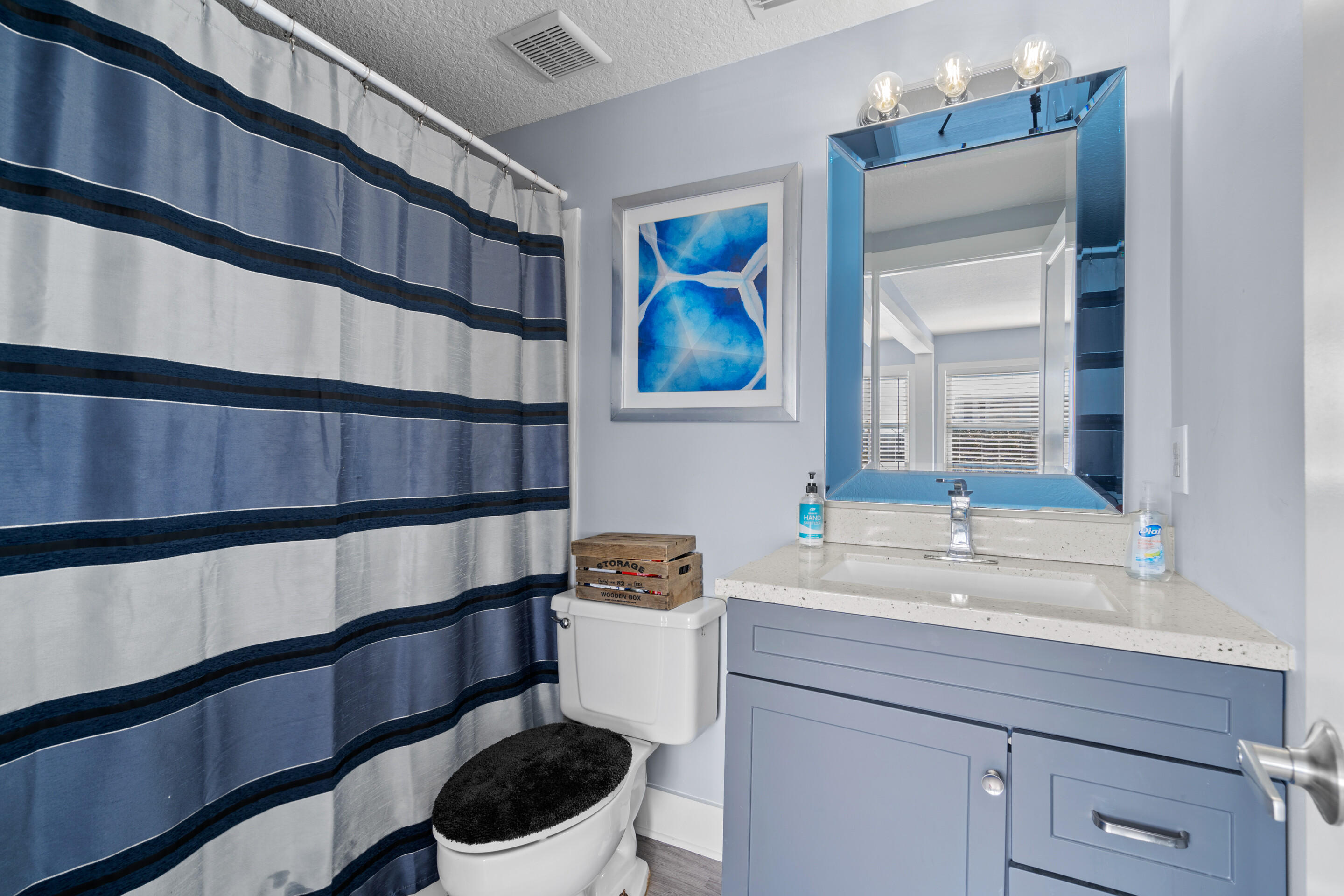 50 Cubbedge Road St. Augustine, FL 32080 - Photo 20 of 26 a bathroom with a sink a toilet and a mirror