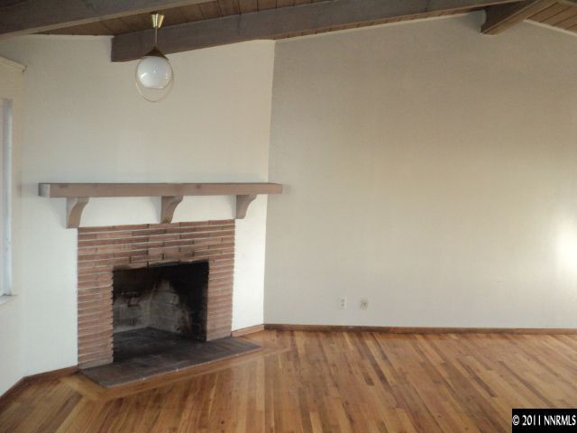 740 Reeves Avenue Reno, NV 89503 - Photo 2 of 9 a view of empty room with wooden floor and fireplace