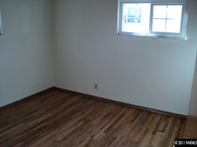 740 Reeves Avenue Reno, NV 89503 - Photo 4 of 9 an empty room with wooden floor and windows