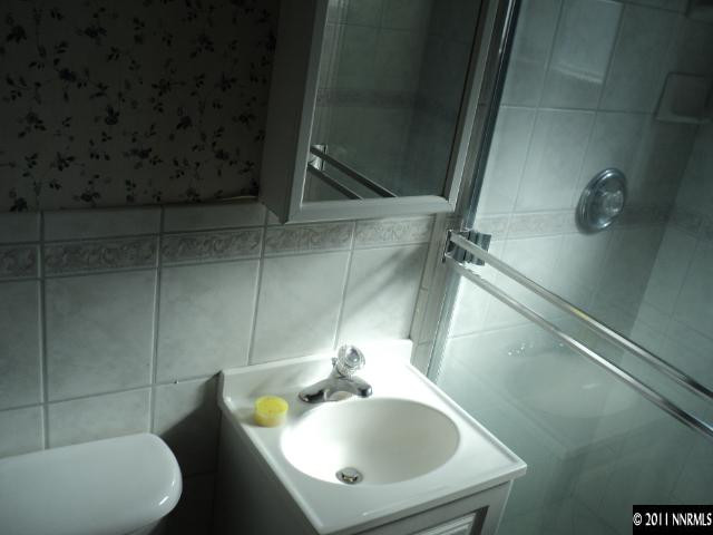 740 Reeves Avenue Reno, NV 89503 - Photo 7 of 9 a bathroom with a sink and mirror with toilet