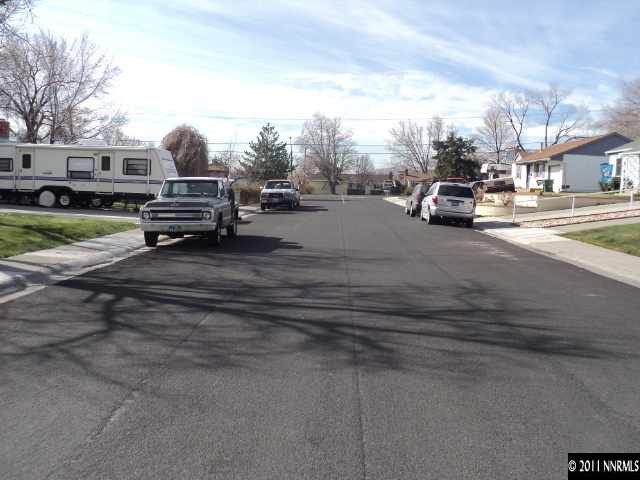740 Reeves Avenue Reno, NV 89503 - Photo 9 of 9 a view of road with card parked on side and retail shops