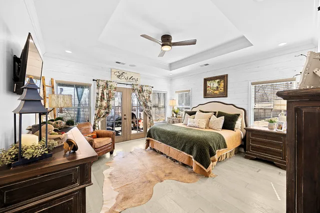 a bedroom with a large bed and a tv