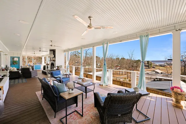 a living room with furniture and a large window with balcony view