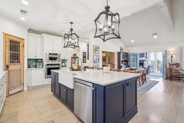 a living room with furniture a clock and white walls