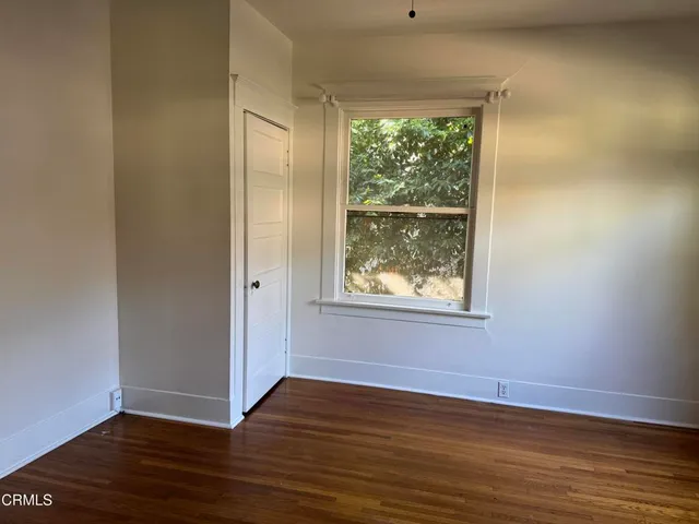 a white toilet sitting next to a bathroom sink and a window