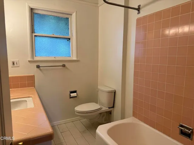 a bathroom with a shower and a sink