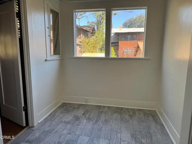 a view of backyard with a barn and a large tree