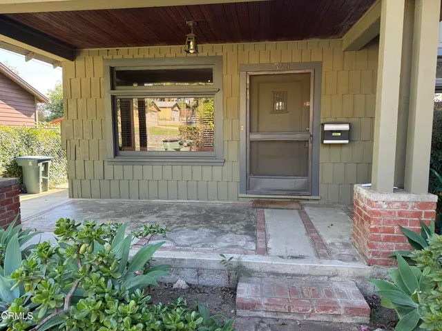 a living room with wooden floors and fireplace