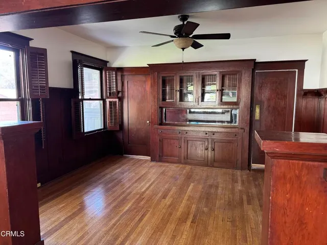 a view of a kitchen with furniture and wooden floor