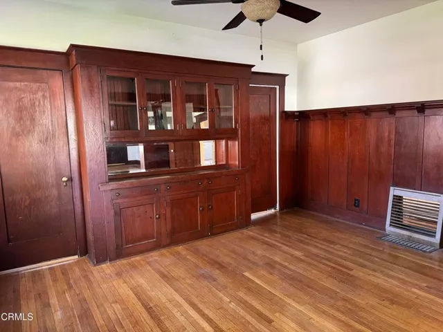 a kitchen view with wooden floor and electric appliances