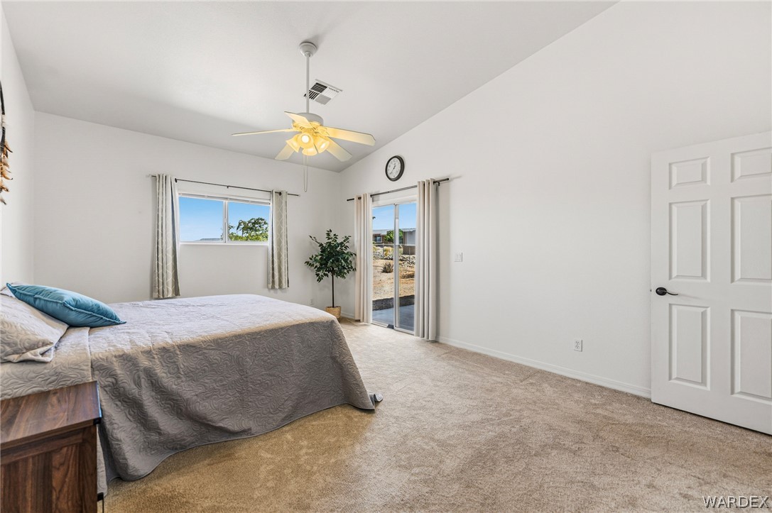 9332 Branded Road Kingman, AZ 86401 - Photo 13 of 44 a spacious bedroom with a bed and a chandelier