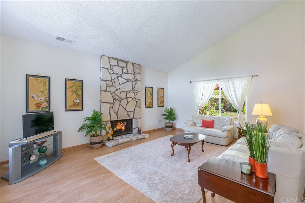 25610 Fallenleaf Drive Torrance, CA 90505 - Photo 7 of 49 a living room with furniture a fireplace and a flat screen tv