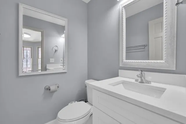 a bathroom with a double vanity sink mirror and shower