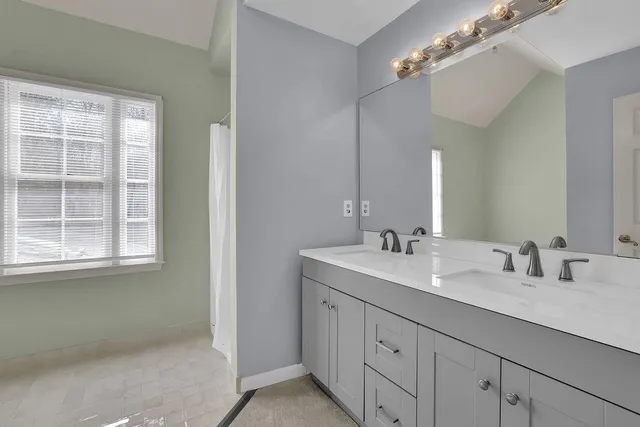 a bathroom with a sink vanity granite and a mirror