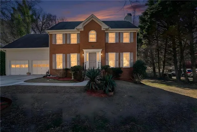 a view of an empty room with chandelier fan
