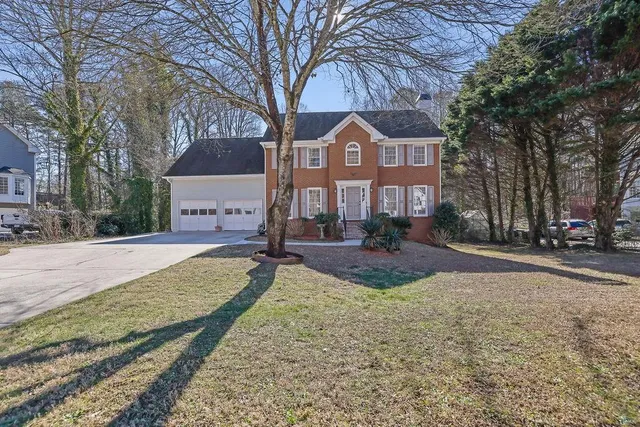 a view of an empty room with chandelier fan