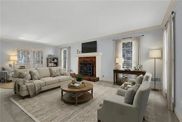 a living room with furniture a fireplace and a flat screen tv