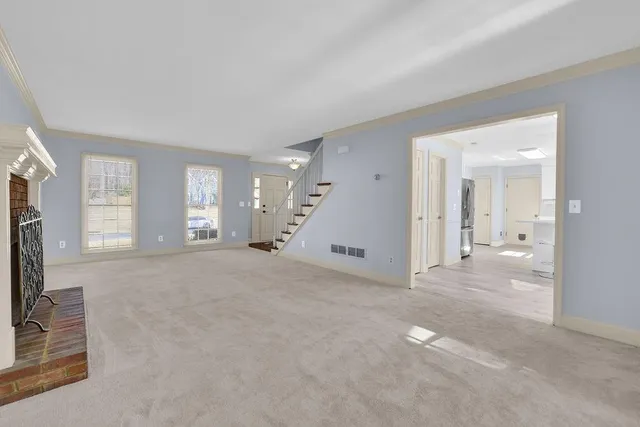 a view of empty room with windows and ceiling fan