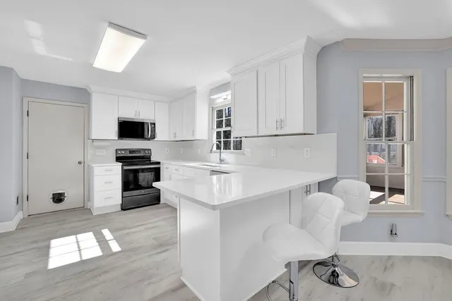a view of wooden floor and windows in a room